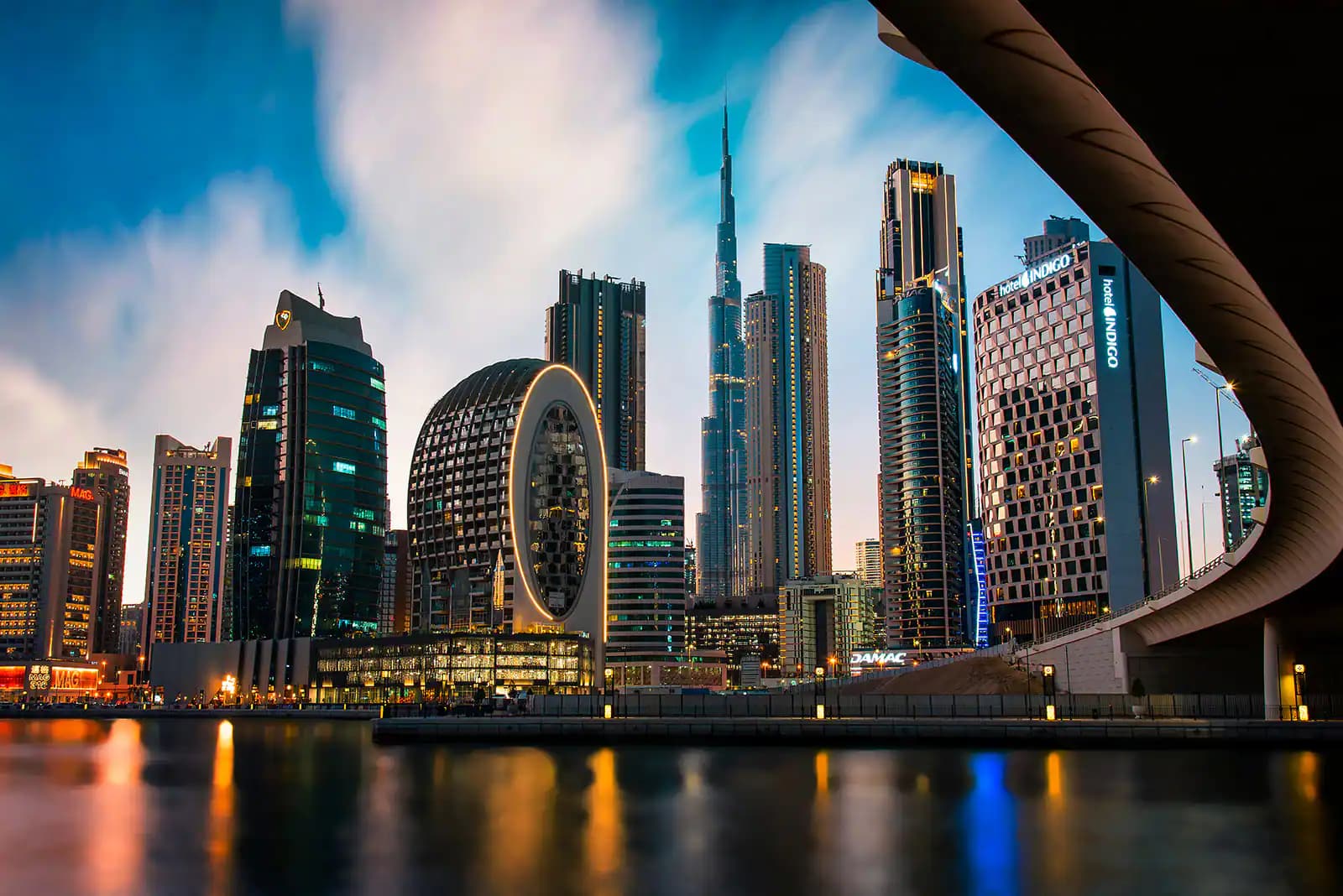 The Business Bay skyline in Dubai at dusk, with the Burj Khalifa behind it